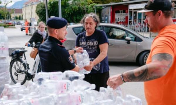 Citizens of Klagenfurt picking up bottles of water in the town centre